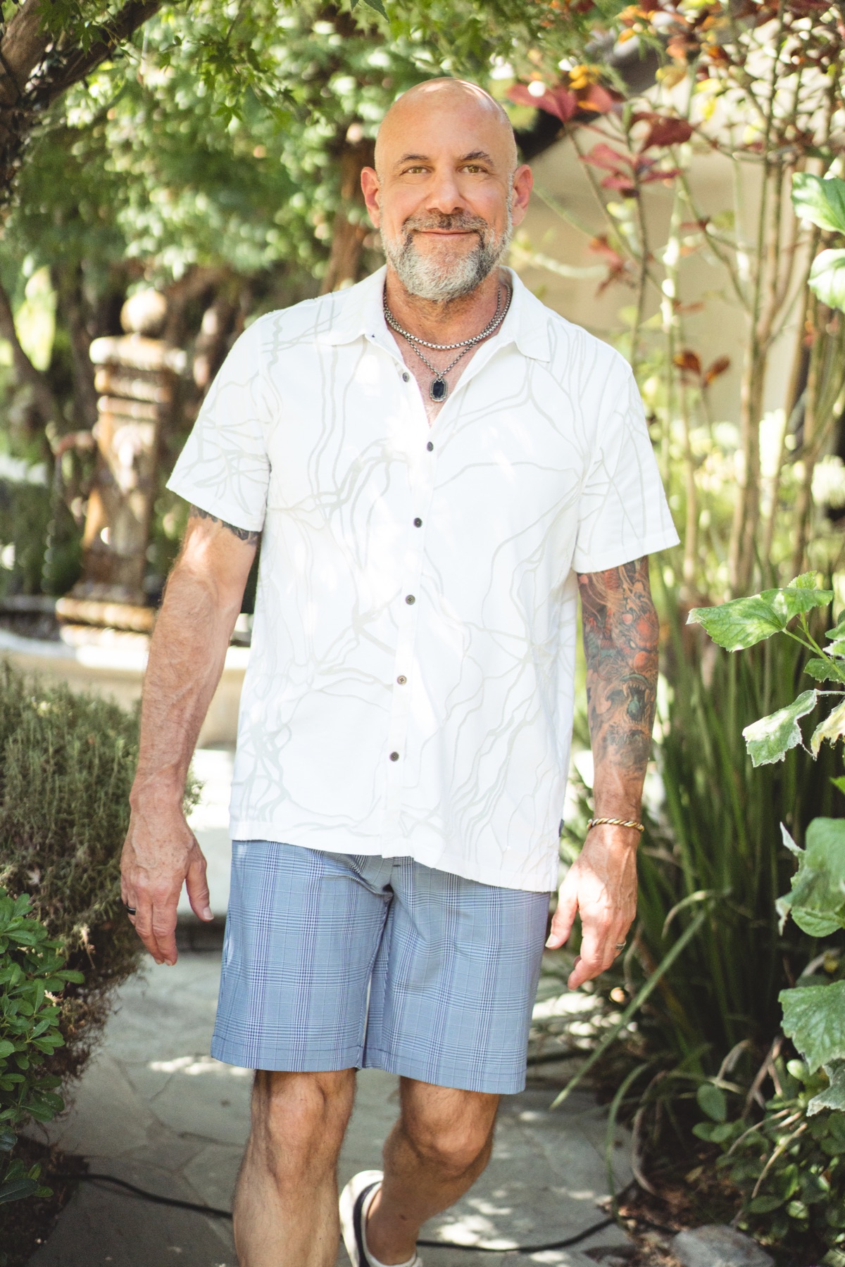 Bentley Richards standing in a sunlit garden